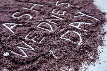 Ash wednesday word written in ash and christian cross symbol as a religion concept