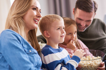 Close up of family watching tv at home