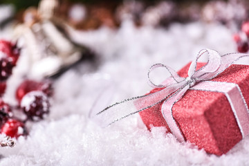 Christmas Gift Box with white Ribbon in snow.