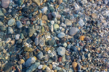 Colorful rocks and pebbles under the clear water
