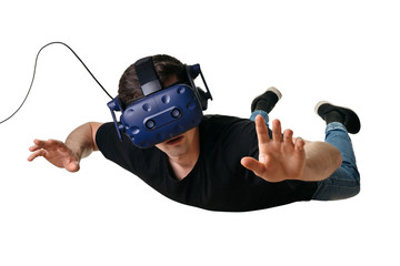 Young man flying in zero gravity space and experiencing virtual reality in 3d goggles, isolated on...