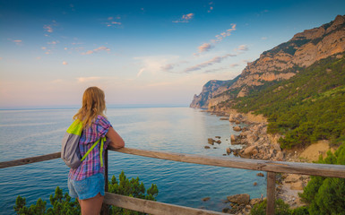 Girl with backpack enjoy the view of Crimea