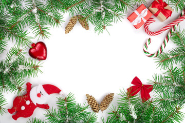 Christmas Frame of Fir tree branch with candy canes and snow isolated on white background with copy space for your text