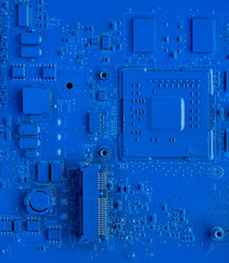 Computer motherboard. Classic blue background with pc backdrop, close up. Single color microchip