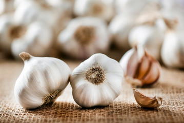 Garlic clove and bulb in wooden basket vintage background.