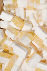 Lokum the “Turkish Delight”, famous Istanbul sweet dessert, confectionery shop. Pink and white color dislay on counter top during street food festival. Traditional homemade specialty to sell in market