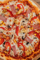 Pepperoni Pizza with Mozzarella cheese, Ham, Tomatoes, pepper, Spices . Italian pizza.