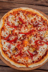 Pizza with Mozzarella cheese, salami, Tomatoes, pepper, Spices. Italian pizza