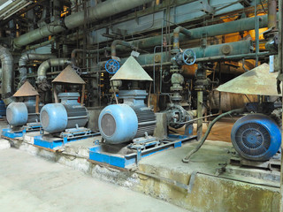 Industrial big water pumps with electric motors, pipes, tubes, equipment and steam turbine at power plant