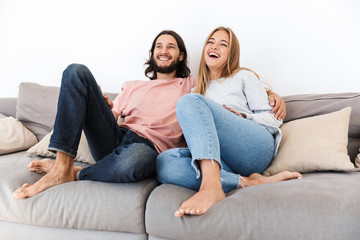Obraz premium Couple on sofa watch tv film indoors at home.