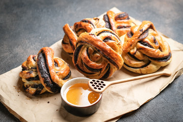 Homemade buns with dark chocolate with honey on a dark background copy space top view.