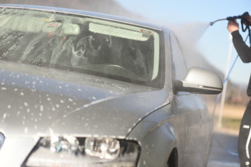 Manual car wash with pressurized water jet. Cars cleaning concept.