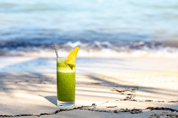 green smoothie cocktail on beach