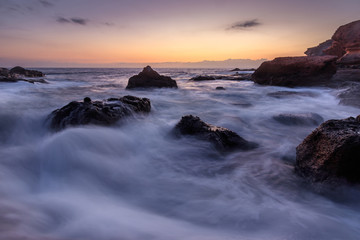Sea wave on long exposure during sunset on the seashore
