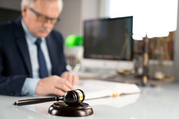 Consultation with a lawyer concept. Attorney at the office. Mallet and documents on the glass table.