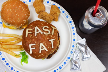Juicy fast food burgers letters on a juicy burger. Unhealthy eating. Junk food concept.