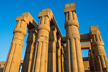 Ancient egyptian hieroglyphic carvings on columns in temple
