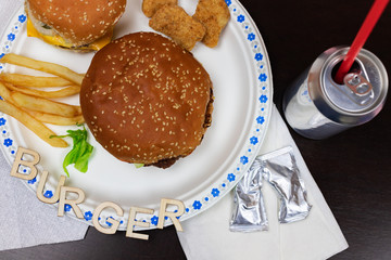 Delicious burger with fries on white plate. Word burger on the plate.