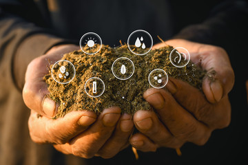 Manure or dung in the hands of a farmer man and technology icons about decomposition to soil.
