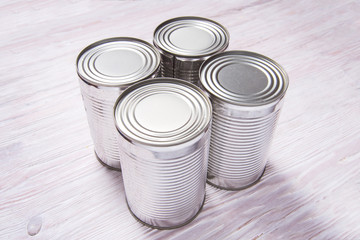 Set of metal tin cans on wooden table