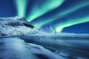 Aurora Borealis, Lofoten islands, Norway. Winter landscape in the night time during polar lights....