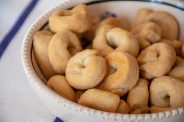 Taralli, toroidal Italian snack foods, common all over the southern half of the Italian Peninsula. A cracker similar in texture to a breadstick, a pretzel, or a sushka in a terracotta pot
