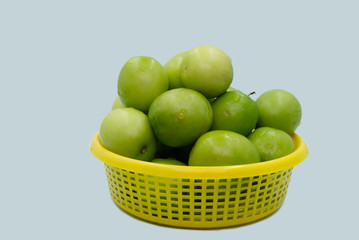 Jujubes or Monkey apple fruit in yellow basket with isolated.