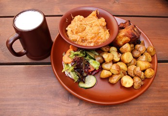 Grilled slice of pork, stewed cabbage, fried potatoes and a glass of village beer
