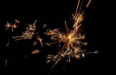 Sparklers burn in the dark, creating a festive mood.