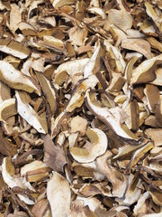 Cut and dried porcini mushrooms. Food background. Rustic style