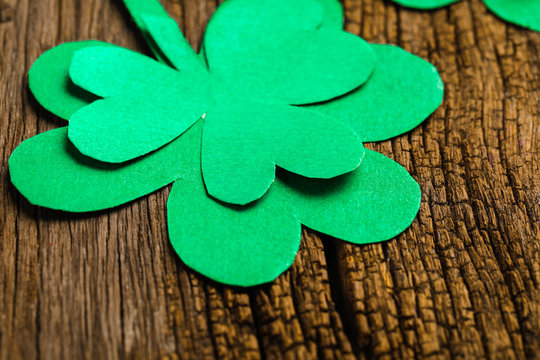 Happy Saint Patrick's mockup of handmade felt hat shamrock clover leaves and confetti on wooden table