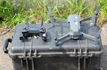 Quadcopter and remote control placed on a box before launching