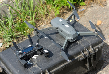 Quadcopter and remote control placed on a box before launching