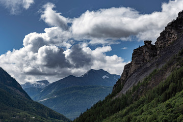 Fototapeta na wymiar Alpine summits near Mont Blanc in clouds, Italy side.