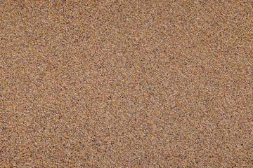 Sand surface and background. Sand Texture. Brown sand. Background from fine sand. Sand background. Closeup of sand pattern of a beach in the summer.