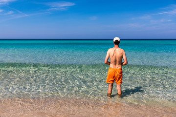 Man in the water at the sea concept of a happy holiday and freedom. Young man in the sea water on...