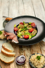 delicious German traditional specialties, Tyrolean ham, maultaschen, sauerkraut, fresh slices of baguette