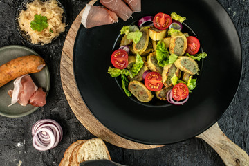 delicious German traditional specialties, Tyrolean ham, maultaschen, sauerkraut, fresh slices of baguette