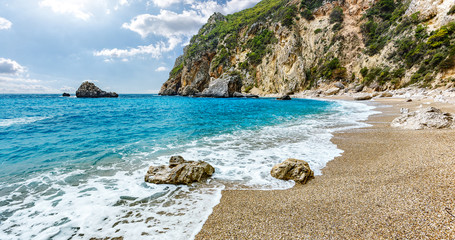 Scenic nature Seascape. Landscape of Ionian Sea. Seashore with cliffs, waves crashing on rocks.  Adventures and exotic travel concept. Wonderful summer view. Amazing Natural Background