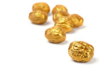 Golden walnuts on a white background