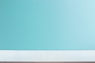 Table top wiht bright blue brick wall background