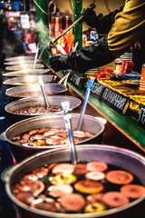 Christmas market seller pours hot mulled wine. Kiev. Ukraine.