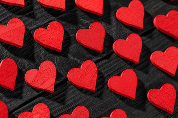 Happy Valentine's day hearts on dark wooden background.