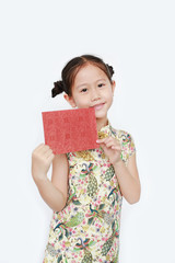 Portrait of happy little Asian girl wearing cheongsam smiling and holding red envelope. Happy Chinese New Year.