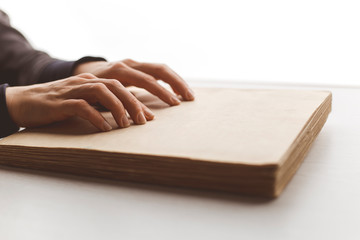 Woman's hands are reading a book.