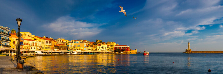 Old port of Chania with flying seagulls. Landmarks of Crete island. Bay of Chania at sunny summer...