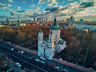 Beautiful panoramic aerial drone view to the Сenter of modern Warsaw city with silhouettes of skyscrapers and Church Karol Boromeusz (at the Powazki Cemetery) in amazing winter January sunset, Poland - obrazy, fototapety, plakaty