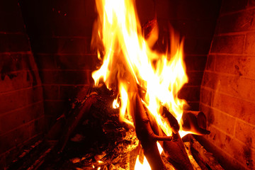 Cosy fireplace with reddish fire at winter time
