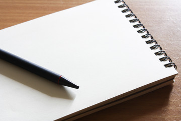 Notebook and pen stationery on the table.