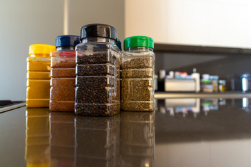 Set of various spices in bottles on the table